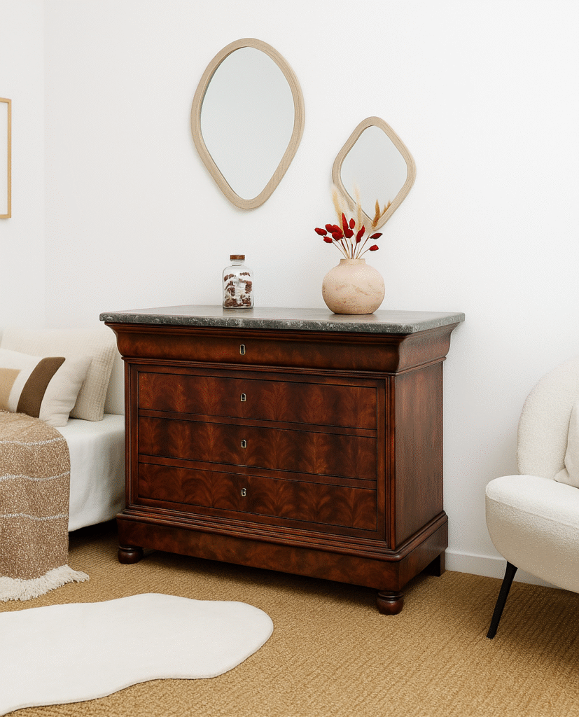 A Louis Philippe Doucine Chest in Mahogany wood, against a white wall in a bedroom
