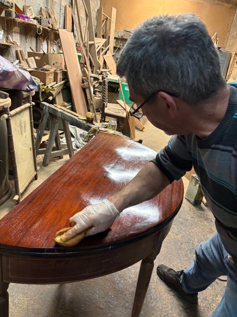 Shaun DALE, Founder and CEO of ABG polishing a french antique table